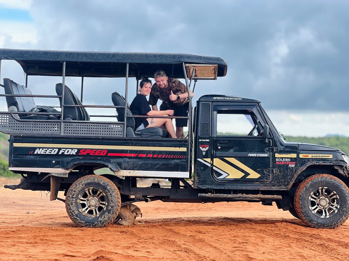 Guests smiling from their safari jeep before a game drive