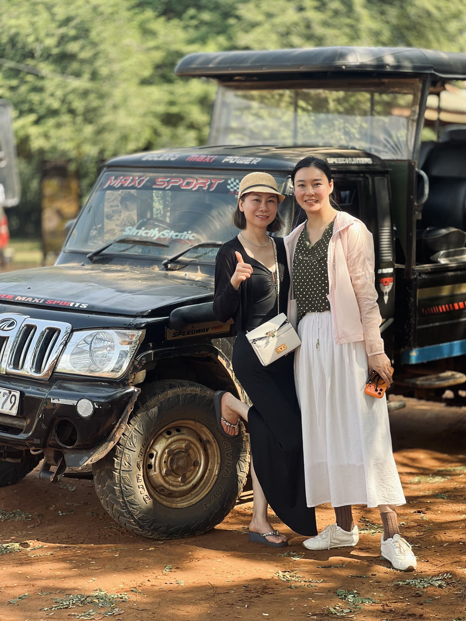 Two guests posing beside the safari jeep after their Yala game drive