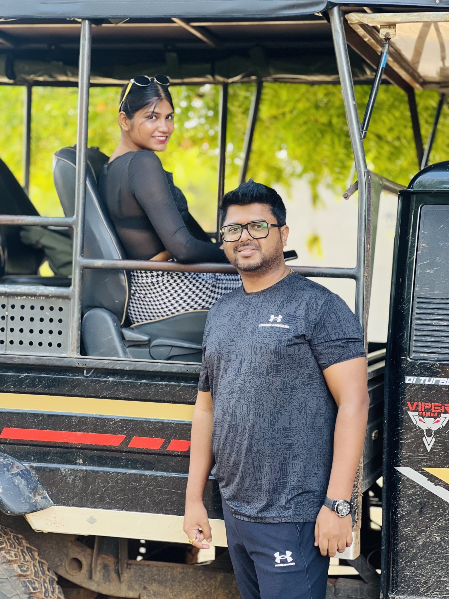 A couple posing together on their safari jeep